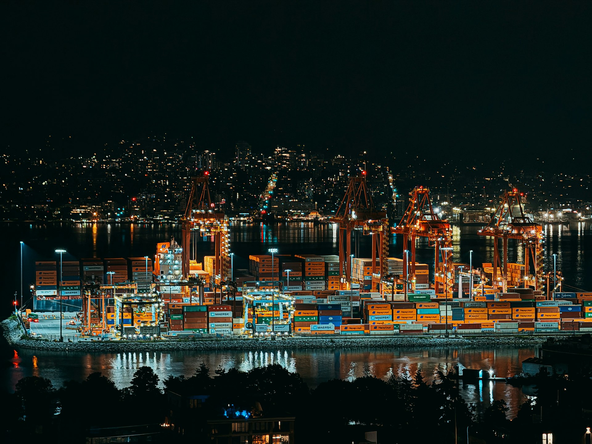 Nighttime view of a brightly lit cargo port.